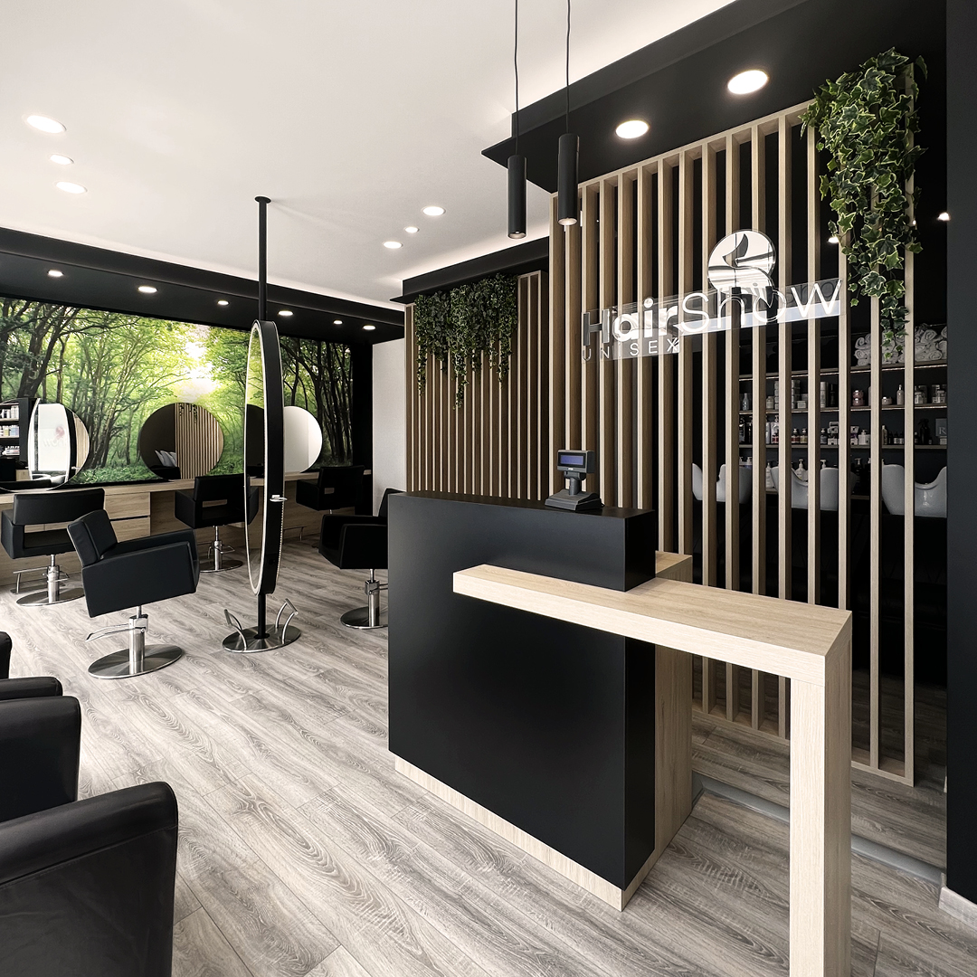 Immagine della reception del salone Unisex. Bancone di legno con struttura nera per la cassa